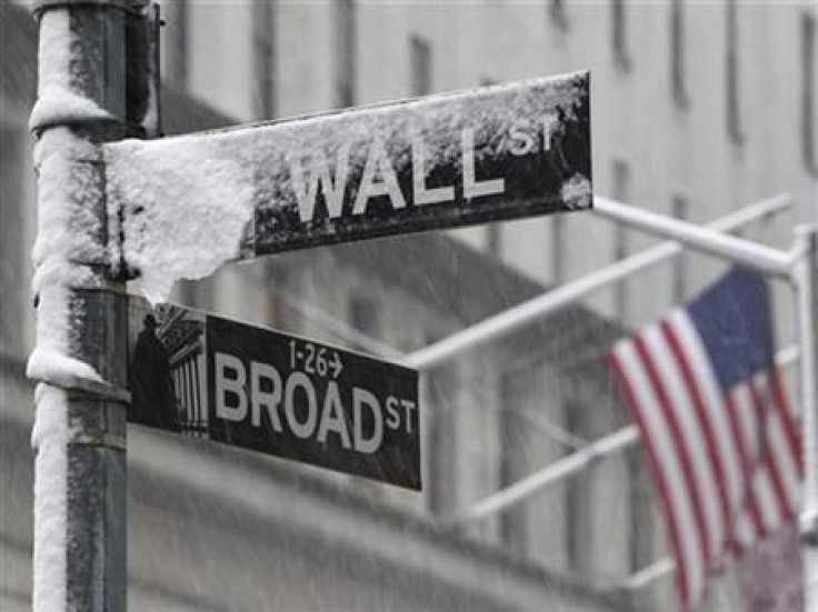 Snow covers a street sign at the corner of Wall St. and Broad St. in New York&#039;s financial district