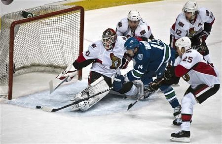  1 / 5 Main Image Main Image Main Image  Vancouver Canucks Alex Burrows scores against Ottawa Senators goalie Brian Elliot during the first period of their NHL game in Vancouver, British Columbia February 7, 2011. Trying to stop Burrows are Senators Chris