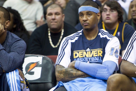 Denver Nuggets Anthony on bench during loss to New Jersey Nets in their NBA basketball game in Newark.