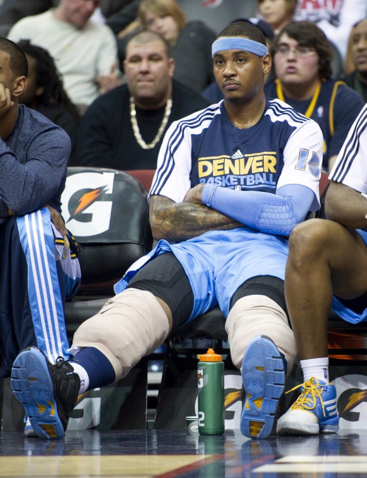 Denver Nuggets Anthony on bench during loss to New Jersey Nets in their NBA basketball game in Newark.