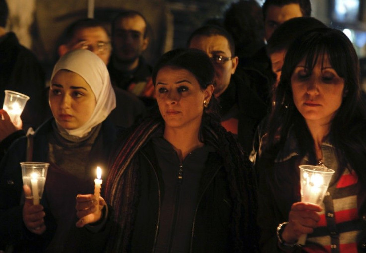 Syrian and Palestinian activists hold candles during a candlelight in support of the protests in Egypt in front of the Egyptian embassy in Damascus