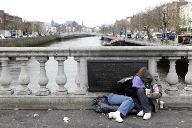 Homeless people beg for money on O'Connell bridge in central Dublin
