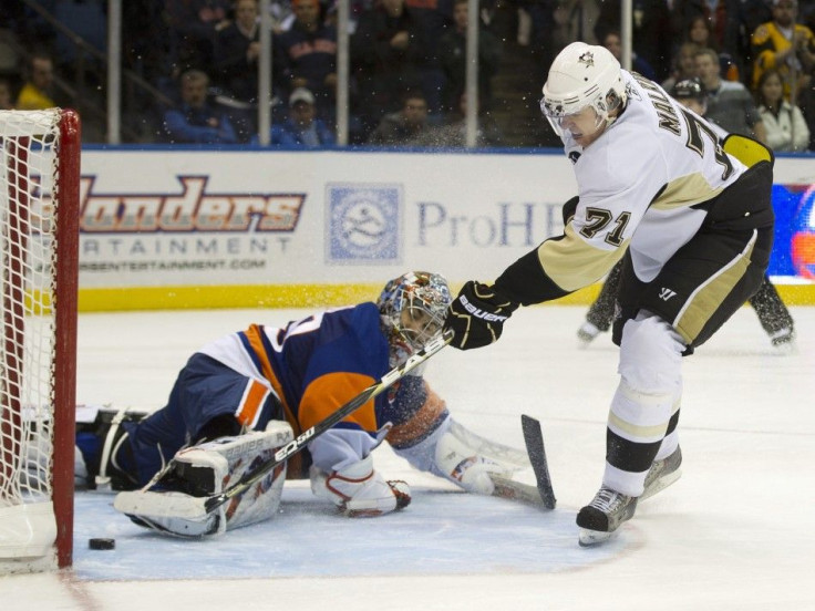 Pittsburgh Penguins center Malkin scores past New York Islanders goalie DiPietro in a shootout in Uniondale, New York.