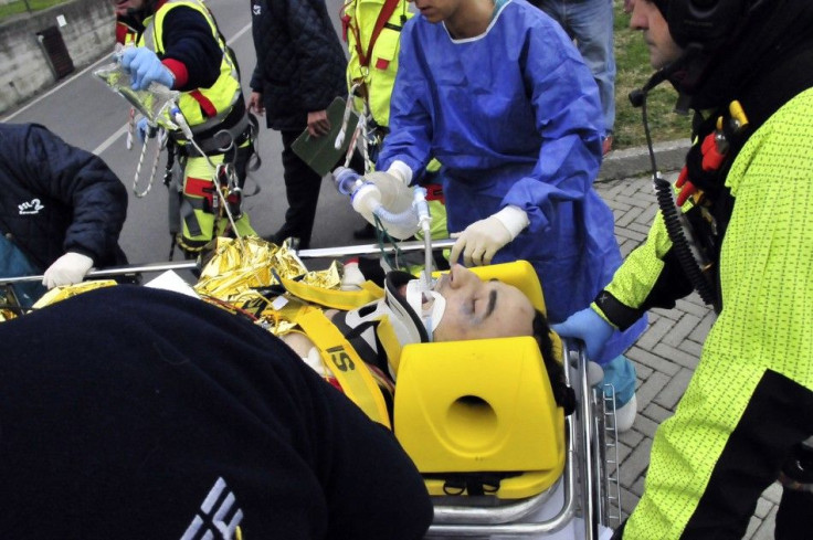 Rescue workers carry Formula One driver Kubica of Poland following an accident in a rally car during a minor rally near Genoa.