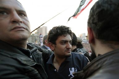Google Inc executive Wael Ghonim is escorted through a mass crowd inside Tahrir Square in Cairo