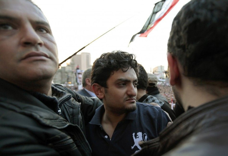 Google Inc executive Wael Ghonim is escorted through a mass crowd inside Tahrir Square in Cairo