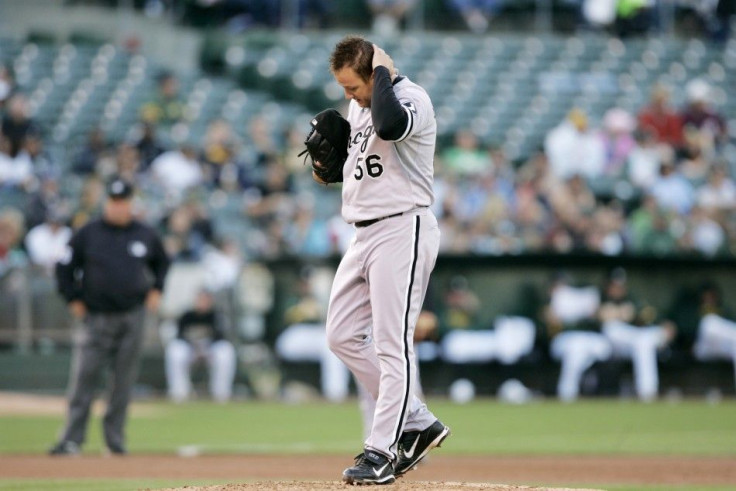 Chicago White Sox Mark Buehrle rubs his head as he walks on the mound in the third inning of their MLB American League baseball game against the Oakland Athletics in Oakland, California July 23, 2010.