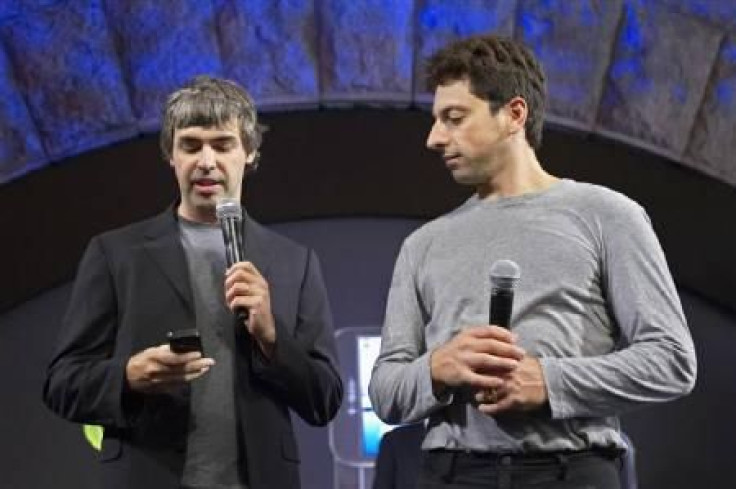 Larry Page (L) and Sergey Brin, founders of Google, show the G1 phone running Google's Android software in New York September 23, 2008.