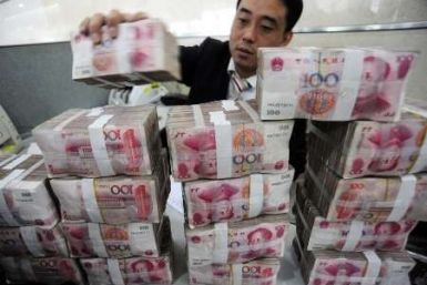 An employee counts Renminbi banknotes at a Bank of China branch in Hefei, Anhui province November 17, 2009.International Monetary Fund chief Dominique Strauss-Kahn said on Thursday the Chinese yuan should be given a greater role within a restructured inte