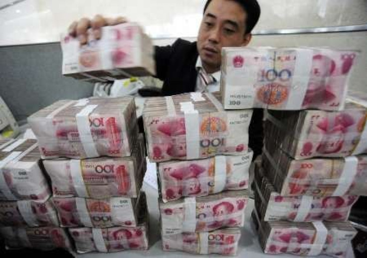 An employee counts Renminbi banknotes at a Bank of China branch in Hefei, Anhui province November 17, 2009.International Monetary Fund chief Dominique Strauss-Kahn said on Thursday the Chinese yuan should be given a greater role within a restructured inte