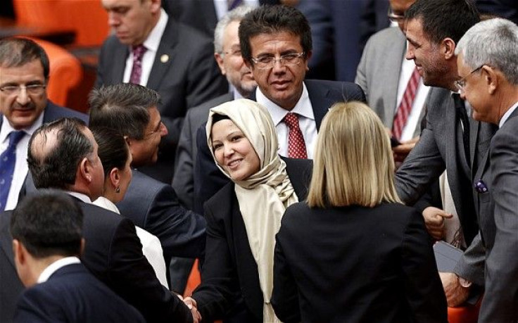 Turkey's ruling AKP politician Nurcan Dalbudak is congratulated by her party's lawmakers as she attends the general assembly wearing her headscarf at the Turkish Parliament in Ankara