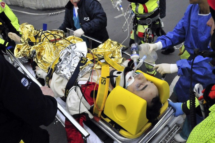 Rescue workers carry Formula One driver Kubica of Poland following an accident in a rally car during a minor rally near Genoa.