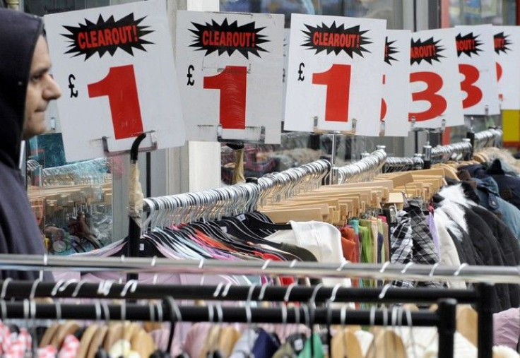 A shopper passes a discount high street store in north London