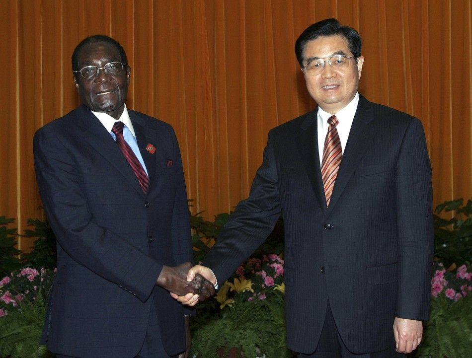 Zimbabwes President Mugabe shakes hands with Chinas President Hu in Beijing
