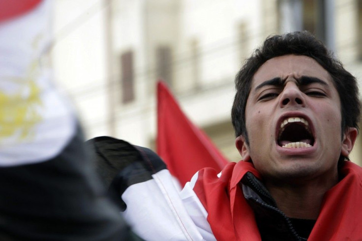 An anti-government protester shouts anti-Mubarak slogans front of the Presidential palace in Cairo
