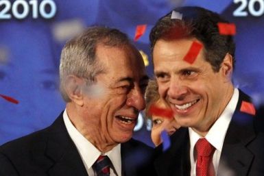 New York Governor Andrew Cuomo (R) shares a laugh with his father former New York Governor Mario Cuomo