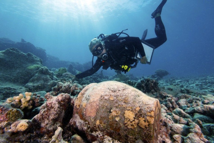 Handout photo of Dr. Kelly Gleason with ginger jar from the 19th century shipwrecked whaling vessel Two Brothers 