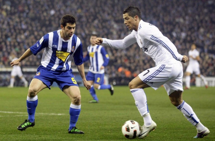 Real Madrid's Cristiano Ronaldo vies for the ball against Espanyol's Jordi Amat during their Spanish First Division match at Cornella-El Prat stadium, near Barcelona.