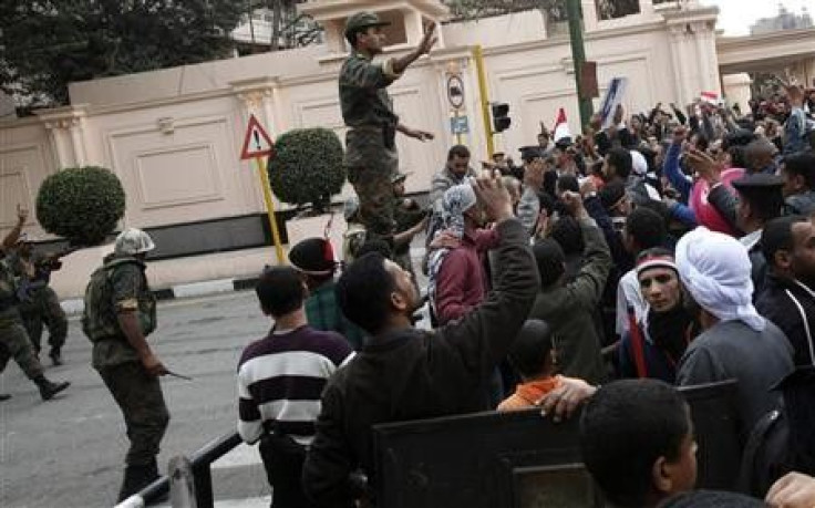 An Egyptian soldier tries to calm opposition supporters outside the Interior Ministry near Tahrir Square in Cairo