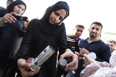 A Bahrain woman shows empty packages 