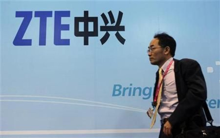 A man walks past a ZTE banner at the Mobile World Congress in Barcelona