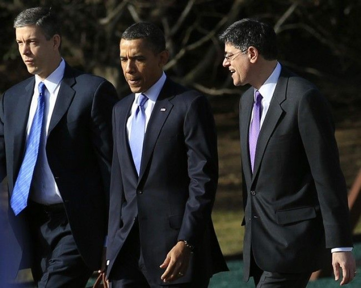 U.S. President Barack Obama (C) walks across the South Lawn at the White House with OMB Director Jack Lew (R) and Secretary of Education Arne Duncan in Washington, February 14, 2011. 