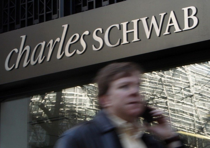 A man walks past a Charles Schwab Investment branch in Washington