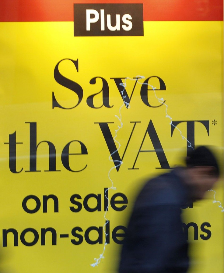 A man passes a sale sign in a shop window in Manchester