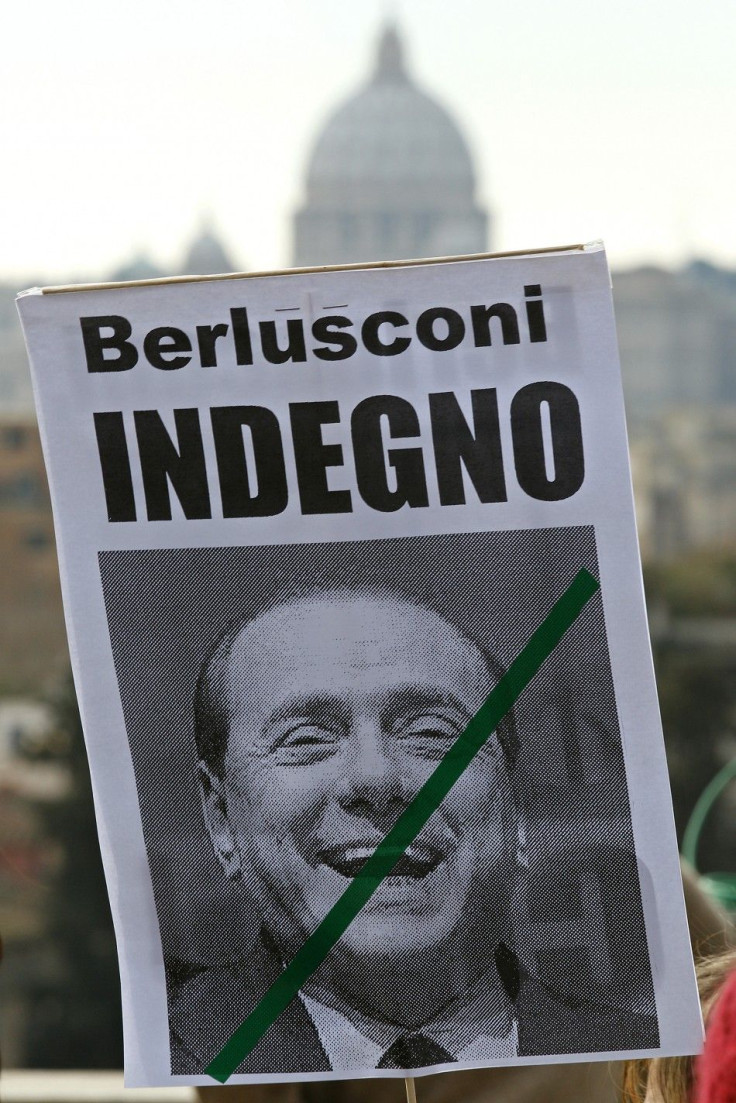 A placard reading &quot;Berlusconi unworthy&quot; is displayed during a demonstration against Italy's Prime Minister Silvio Berlusconi in downtown