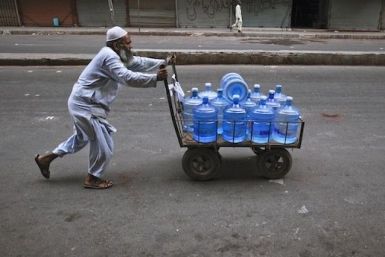 Pakistani man transporting bottled water