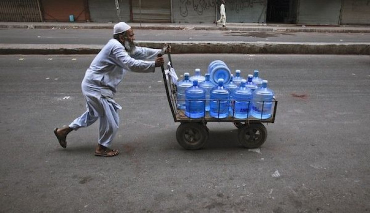 Pakistani man transporting bottled water