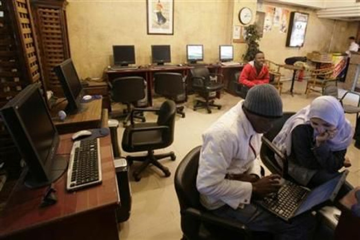 People sit in an internet cafe in Cairo