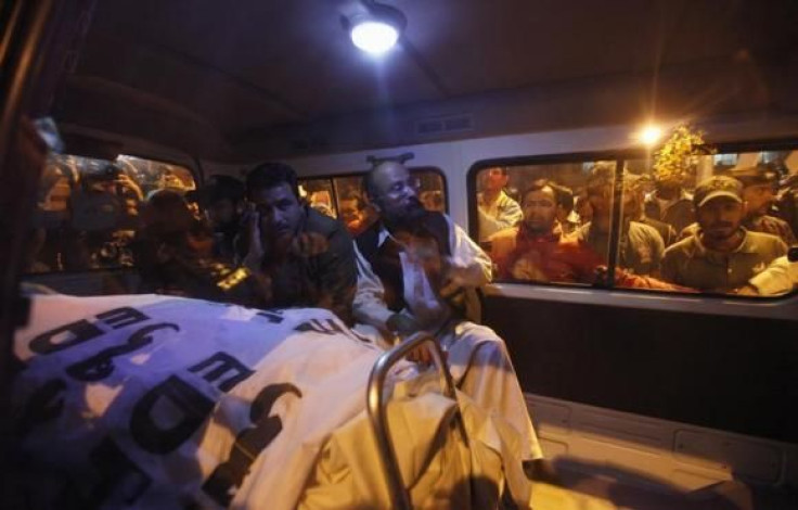 Relatives of Pakistan's Crime Investigation Department (CID) Chief Chaudhry Aslam sit in an ambulance with his body outside Jinnah Postgraduate Medical Centre in Karachi January 9, 2014.