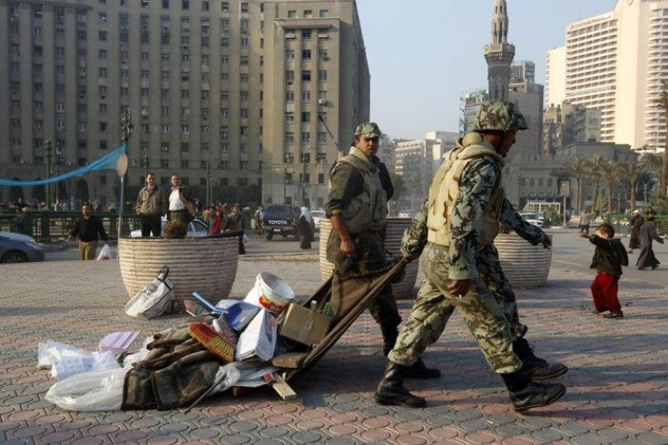 Army soldiers remove makeshift shelters and clear Tahrir Square in Cairo