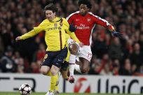 Arsenal's Song challenges Barcelona's Messi during their Champions League quarter-final soccer match in London.