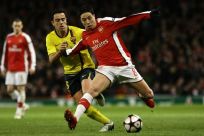 Arsenal's Nasri is challenged by Barcelona's Xavi during their Champions League quarter-final soccer match in London.