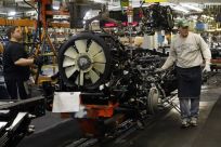 General Motors auto assembly workers lower an engine onto the chassis for Chevrolet Silverados and GMC Sierra pickup trucks at the Flint Assembly in Flint, Michigan
