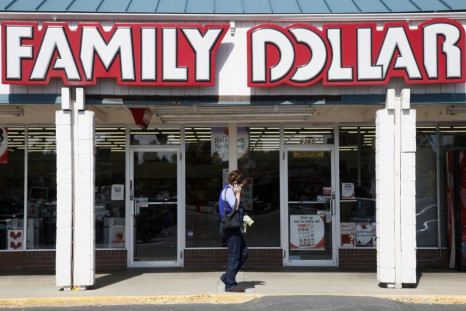 A woman walks by the Family Dollar store in Arvada
