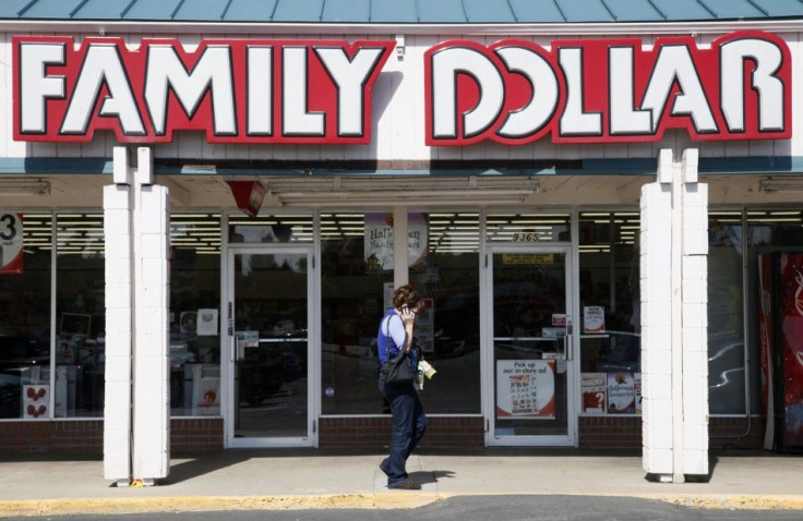A woman walks by the Family Dollar store in Arvada