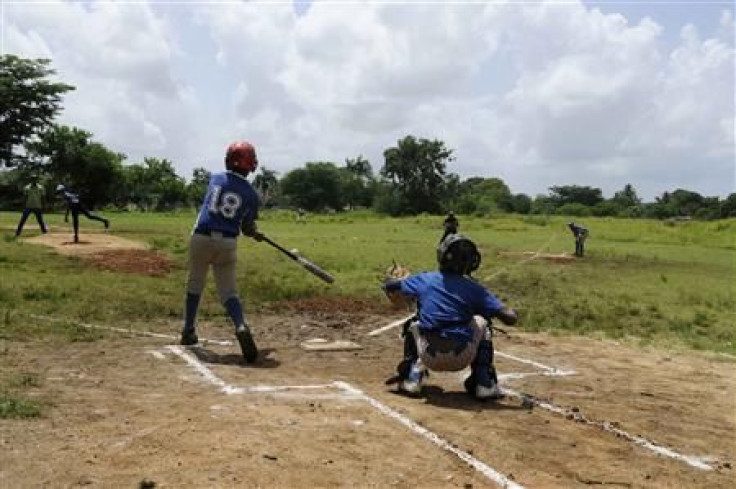 Dominican boys practice baseball at a park in Guerra August 10, 2013. 