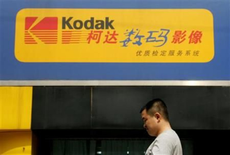 Chinese man walks past a Kodak digital express shop in Beijing.