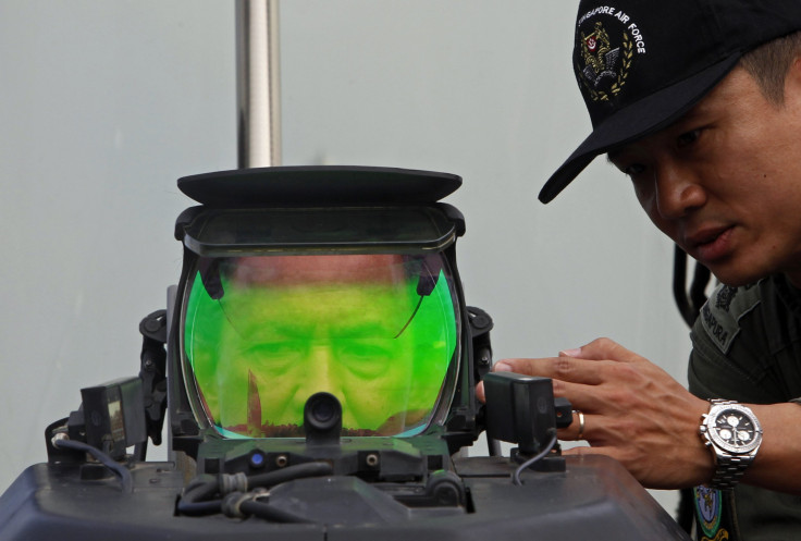 Sultan of Brunei looks through the heads-up display of a Lockheed F-16-D
