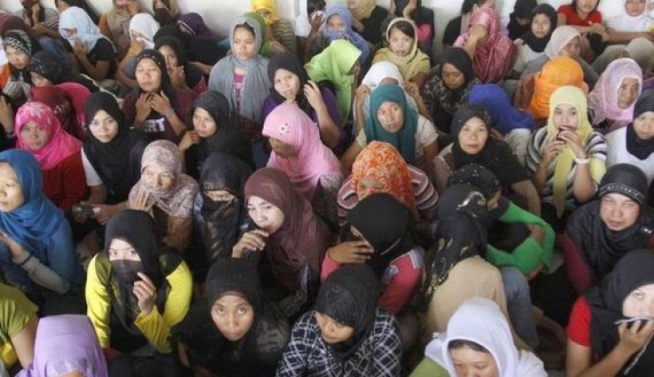 Indonesian workers ready to fly to Saudi Arabia to work as maids wait at a shelter during a police inspection in Bekasi, Indonesia's West Java province.
