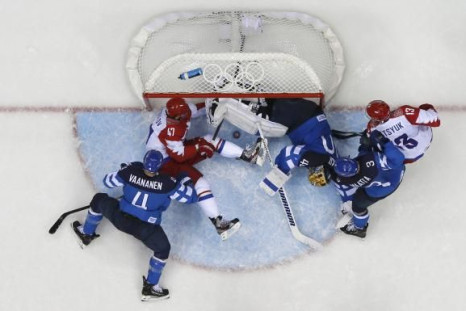 Russia's Alexander Radulov (47) tries to push the puck into the goal as Finland's goalie Tuukka Rask (3rd R) defends during the third period of their men's quarter-finals ice hockey game at the Sochi 2014 Winter Olympic Games February 19, 2014.