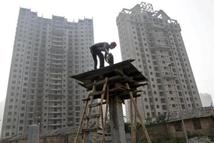 A labourer works at the construction site of a residential complex in Kolkata 