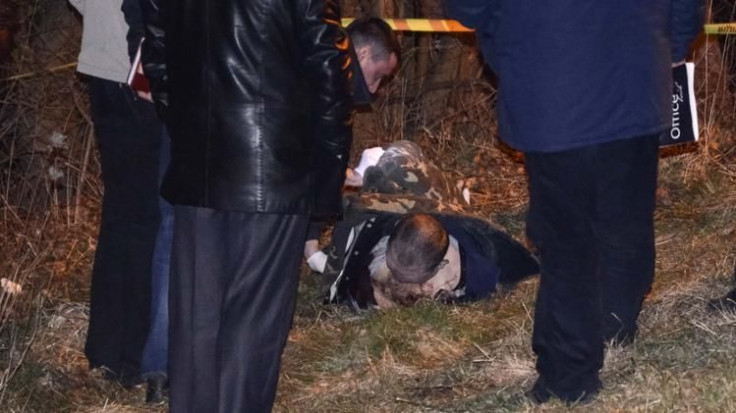 Police look at the body of prominent Ukrainian far-right activist Oleksander Muzychko, also known as Sashko Bily, lying on the ground near Rivne