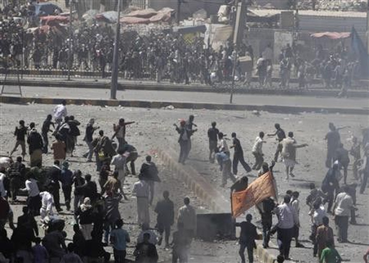 Anti-government protesters (back to the camera) and government backers face each other during clashes in Sanaa 