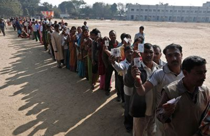 Voters queue at a polling station during the state assembly election in New Delhi on December 4, 2013.