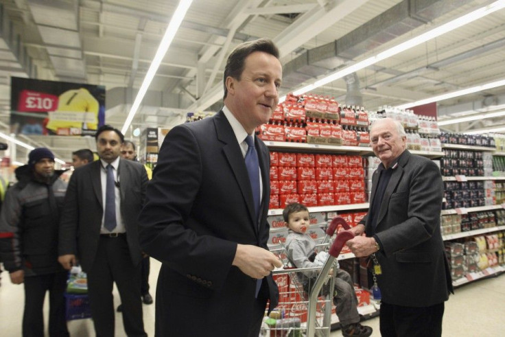  Britain's Prime Minister David Cameron (C) walks around a branch of Sainsbury's supermarket during a visit, in east London February 17, 2011. 