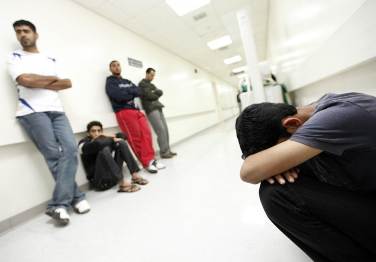 People wait at the Salmaniya hospital to hear about the well-being about their family members who were injured after riot police stormed an anti-government protest camp, in Manama.